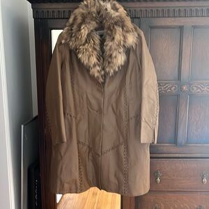 Long leather jacket, with removable fur trim, with unique stitching details.